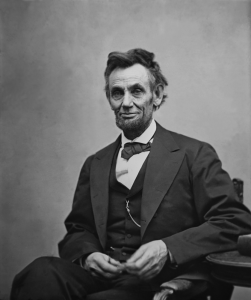 Abraham Lincoln (1809-1865) seated and holding his spectacles and a pencil on Feb. 5, 1865 in portrait by Alexander Gardner