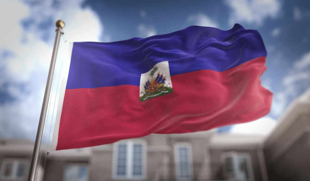 Haiti Flag 3D Rendering on Blue Sky Building Background