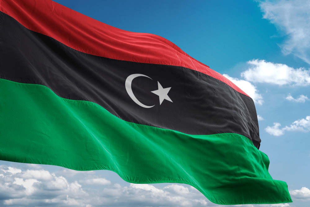 Libya national flag waving in the blue sky realistic 3d illustration