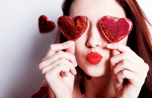 Brunette girl with red hearts on Singles Day