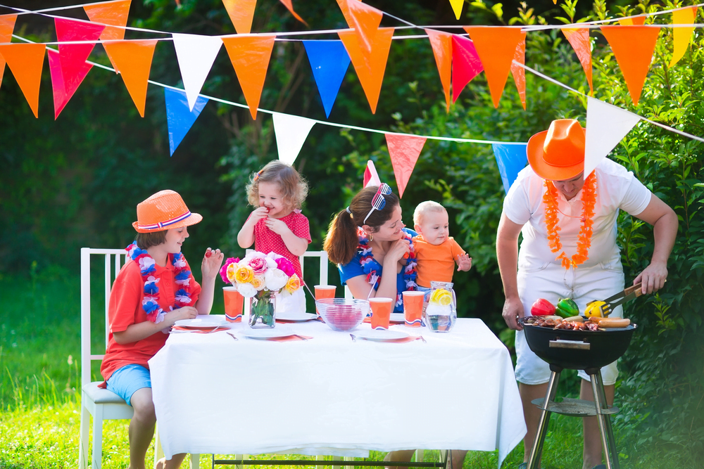Happy big Dutch family with kids celebrating King’s Day