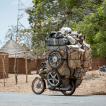 Motorcycle carrying a lot of stuff overloaded, Cameroon Africa